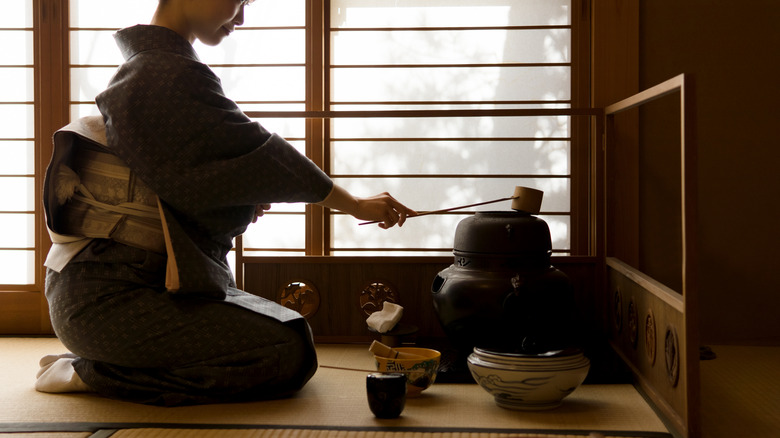 woman in kimono preparing tea