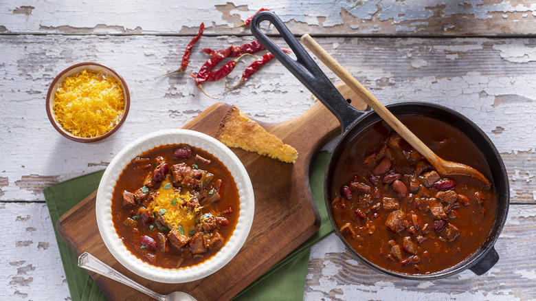 Chili cooking with cheese and cornbread
