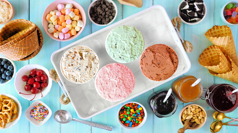 four pints of ice cream and toppings