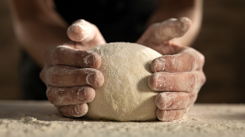 pizza dough being kneaded