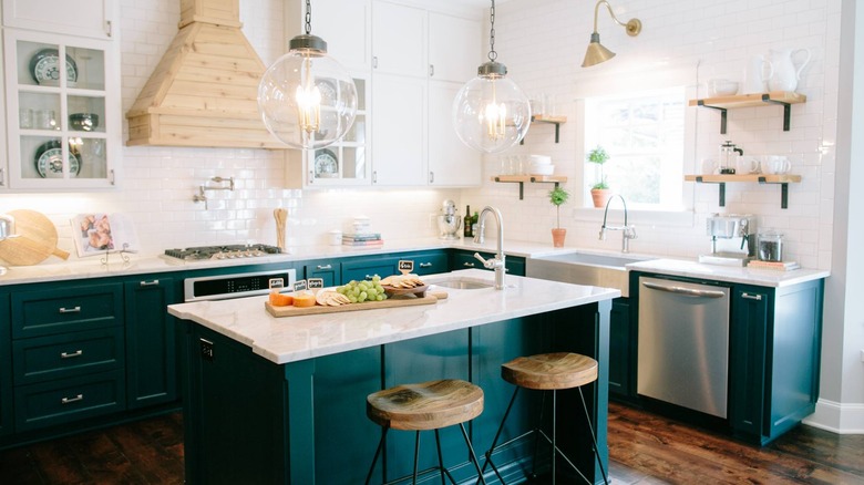 Kitchen with white from the countertops up and a dark greenish blue on the bottom cabinets