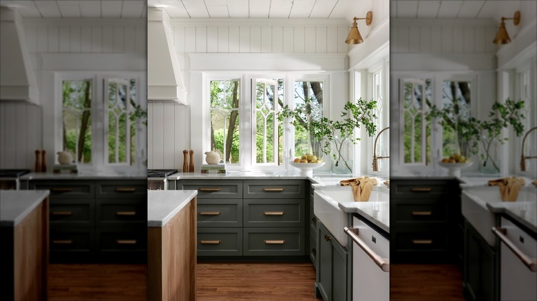 Bright kitchen with white walls and countertops and dark grey lower cabinets