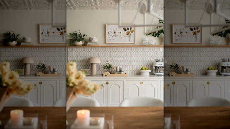 Kitchen with white cabinets, cream walls, and natural wood accents