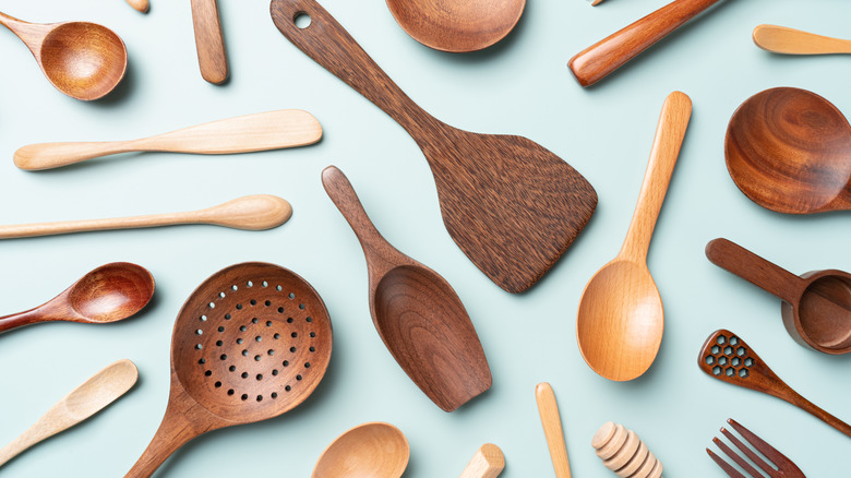 Several styles of wooden spatulas and spoons flat lay.
