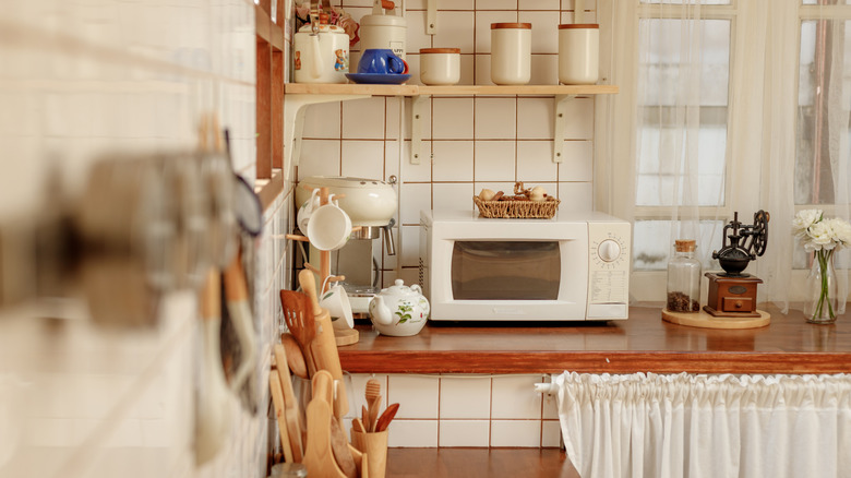 View of kitchen with hanging decor and decorative shelving accents