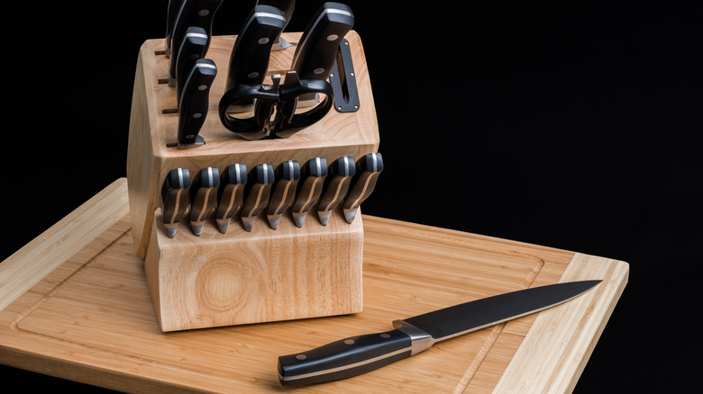 A knife block sitting on top of a cutting board