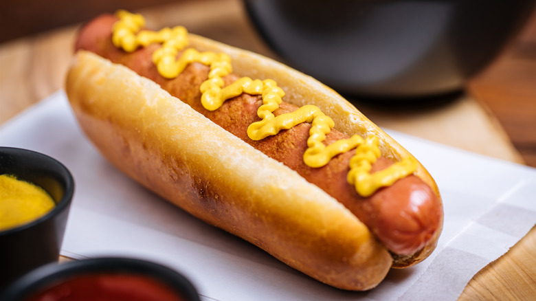 hot dog in a bun with mustard