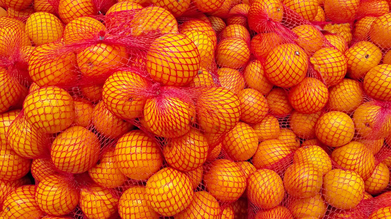 Oranges in red mesh produce bags