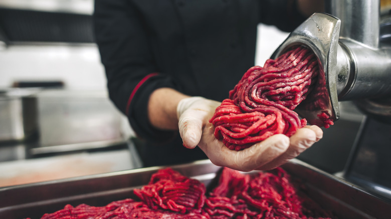 ground beef coming out of a meat grinder