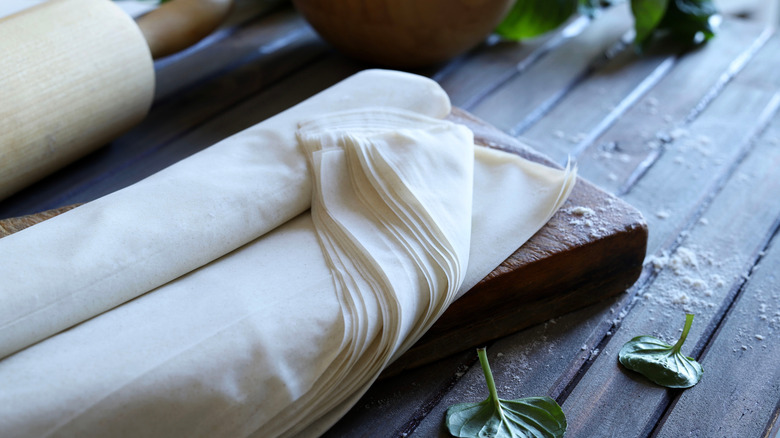 raw phyllo dough on a rustic wood table