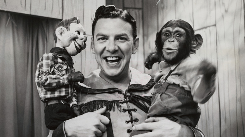 Buffalo Bob Smith holding Howdy Doody ventriloquist dummy and chimp