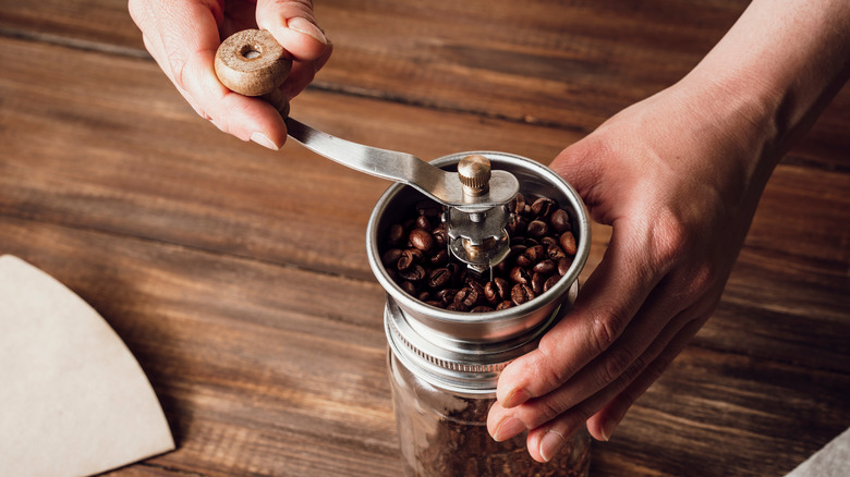 Person grinding coffee beans