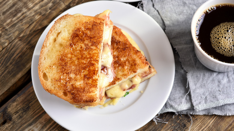 Top-view of a hot ham and cheese sandwich with coffee