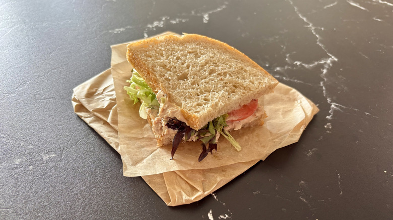 Half of a Panera Bread tuna sandwich on a table