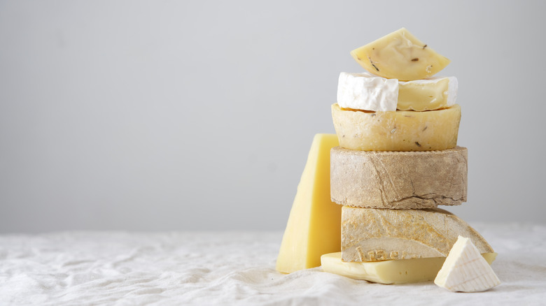 Various blocks of cheese stacked