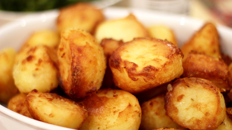closeup of roast potatoes in a white bowl