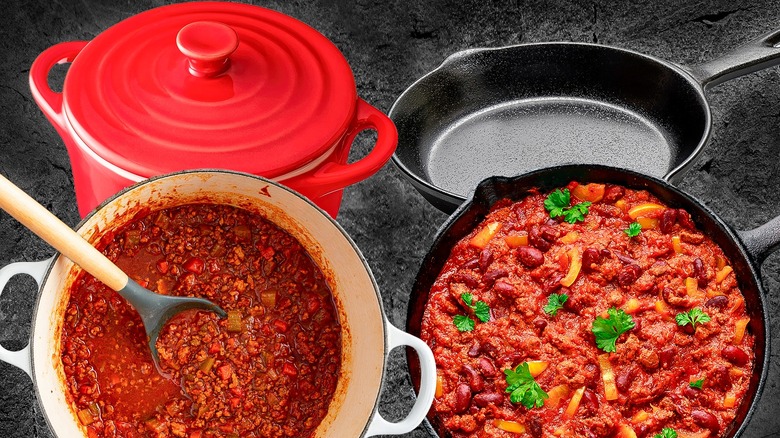 Enamel and traditional cast iron pots with chili