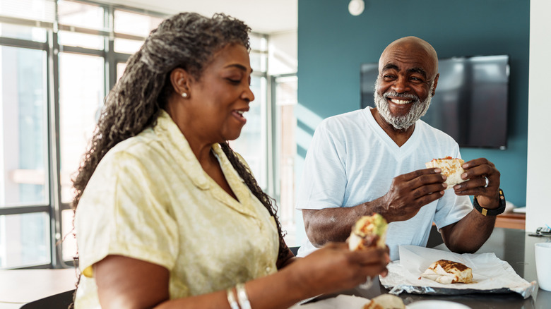 couple eating breakfast burritos