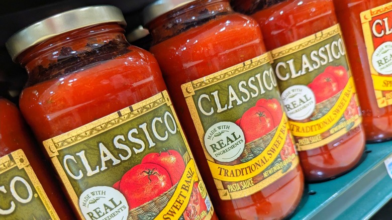 A row of Classico pasta sauce jars on a store shelf