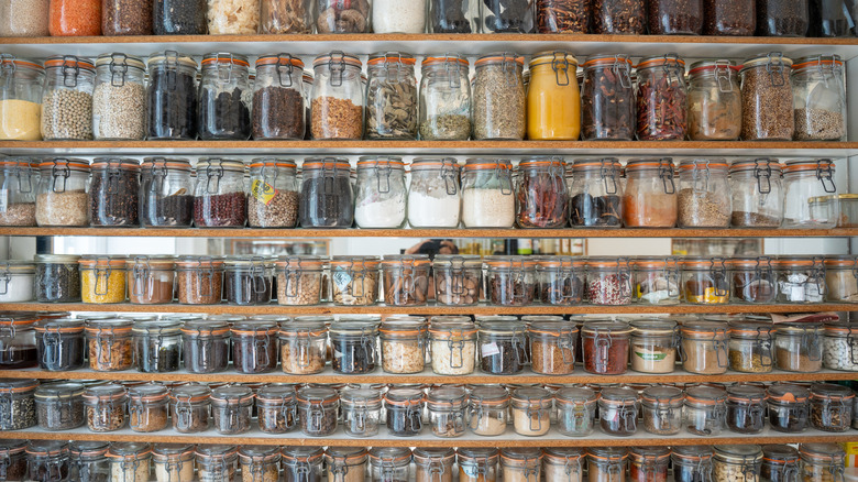 Glass jars of spices on shelving