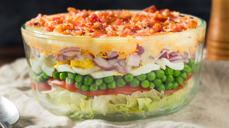 Seven-layer salad in glass bowl