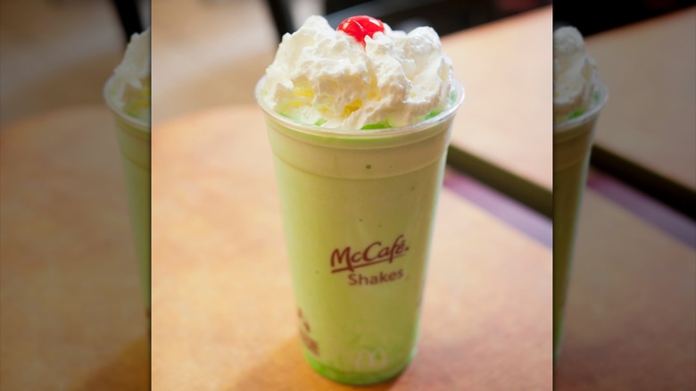 Green McCafé milkshake with whipped cream and a maraschino cherry