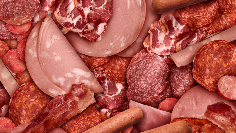 An overhead shot of a variety of deli meats piled together