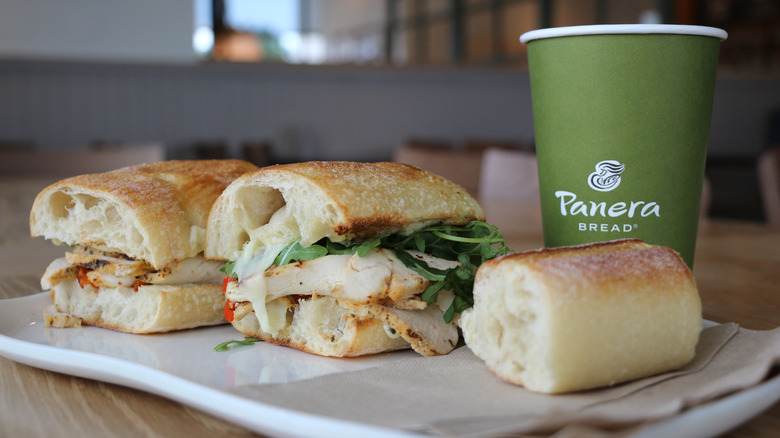 Panera Bread chicken sandwich sliced with drink