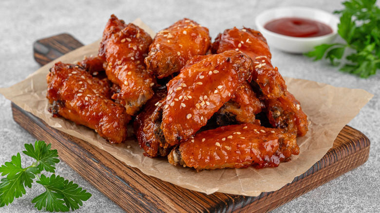 Homemade Buffalo wings on a wooden serving plate