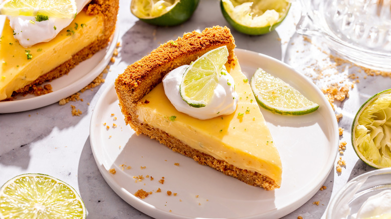 slice of key lime pie with whipped cream on plate