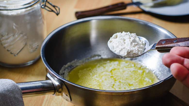 adding flour to melted butter