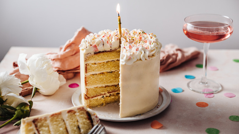 Layered frosted cake with candle