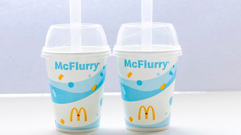 Two McFlurry cups sitting side by side on a counter