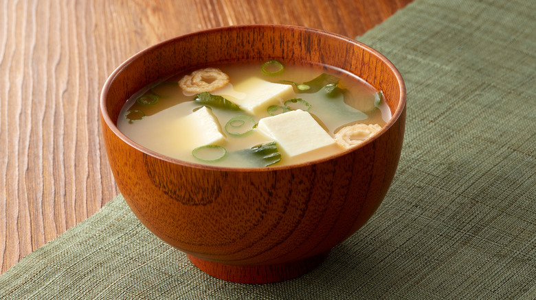 A bowl of miso soup in a wood bowl