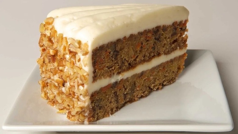 A slice of carrot cake on a white plate