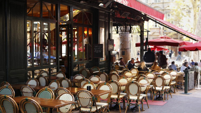 tables set up outside of a French cafe