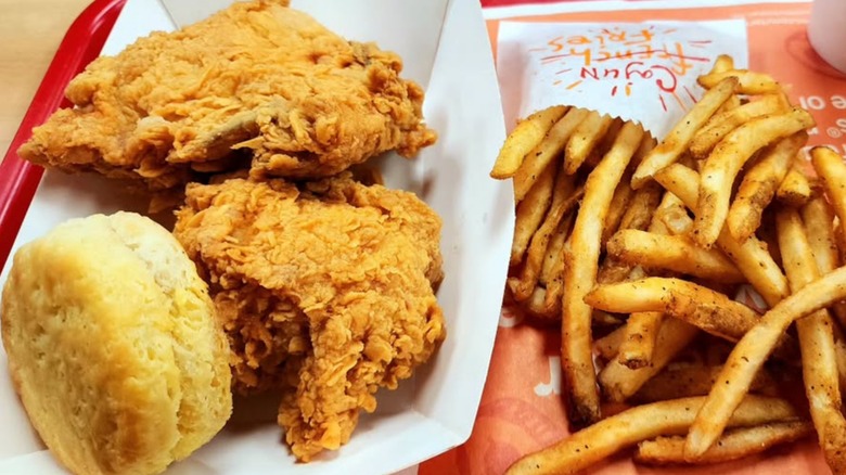 Tray of fried chicken, fries, and a biscuit
