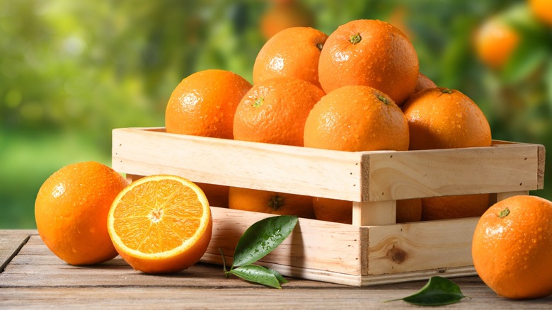 Fresh oranges in a wooden crate