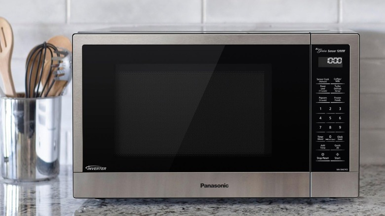 Panasonic microwave on counter with utensils