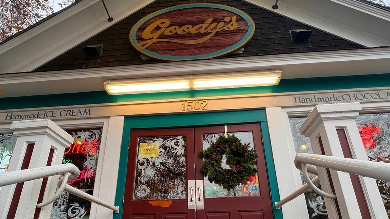 Outside a candy store with a sign that say Goody's