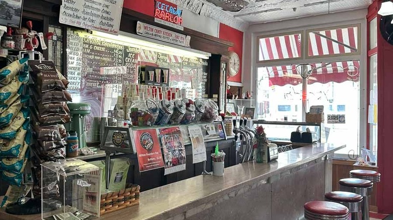 A bar counter in candy store with an ice cream parlor sign