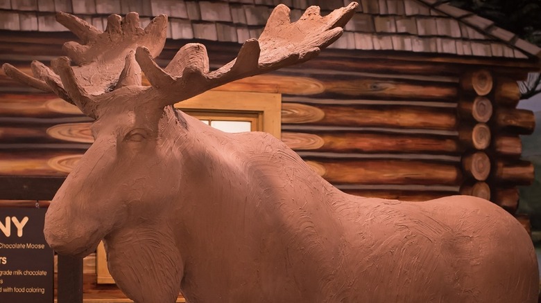 A chocolate life-size moose in a candy store