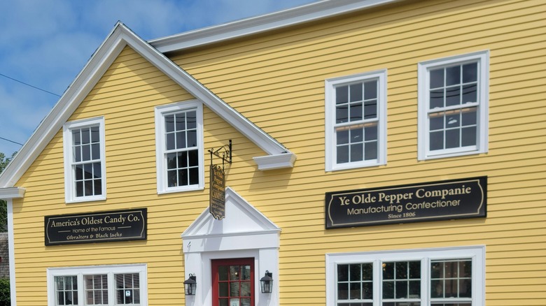 A yellow painted candy store with red door