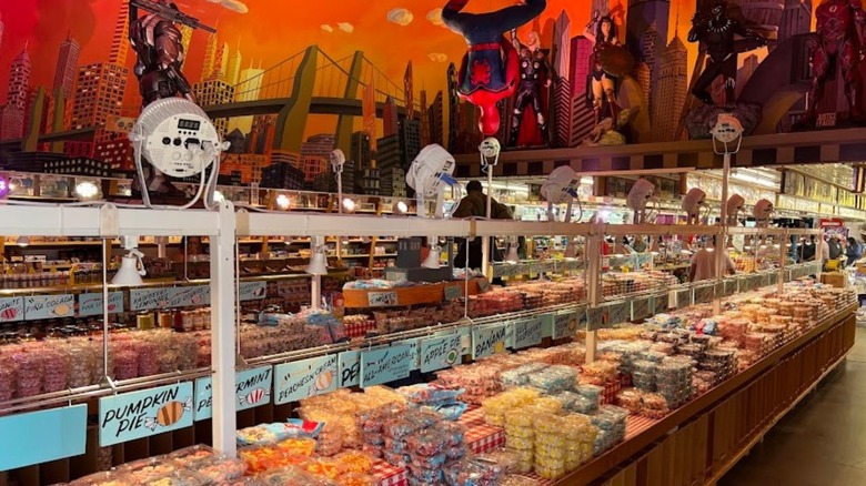 A candy store with superhero characters on the wall