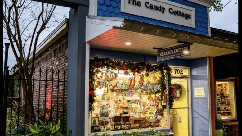 A window in a candy store with the words 'The Candy Cottage'