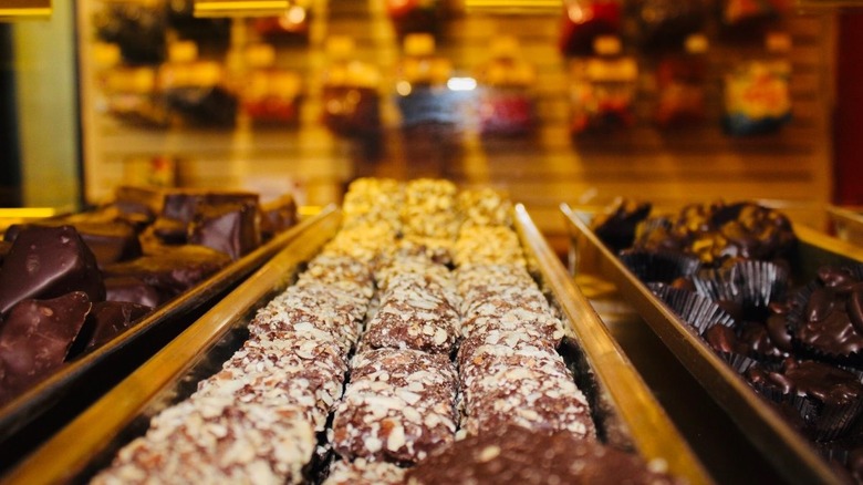 Chocolate candies on trays in a candy store