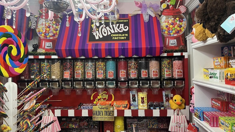 A candy shelf with a Wonka Chocolate Factory sign