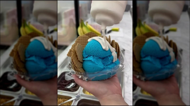 Pouring white chocolate sauce onto scoops of blue moon ice cream