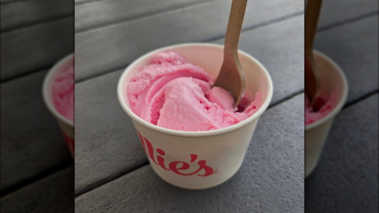 Tub of pink teaberry ice cream with spoon