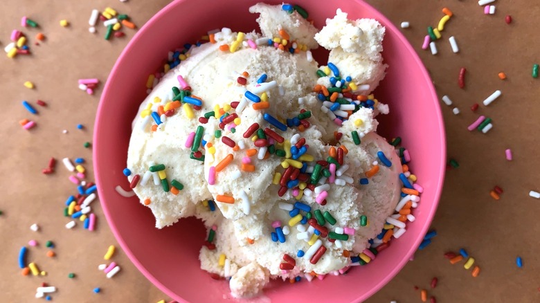 Birthday cake flavored ice cream with rainbow sprinkles in pink bowl